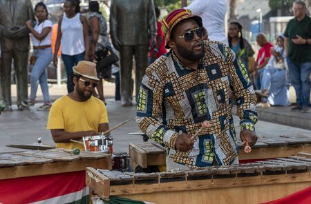 Cape Town, South Africa. Dec 2019. Zylophone player playing in a band busking on the waterfront...