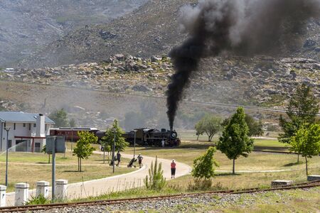Ceres, Western Cape, South Africa. December 2019.  Steam engine hauling passenger coaches on the...