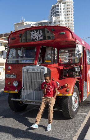 Strand, Western Cape South Africa.  Dec 2019. Vintage fun and party red bus at Strand a populat...