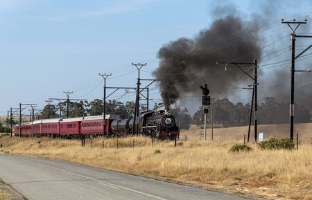 Hermon, Swartland, South Africa. December 2019. Oil burner vintage black locomotive seen passing...