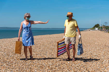 Southsea, Portsmouth, Southern England, UK. May 2020. Woman  wearing a surgical mask  social...