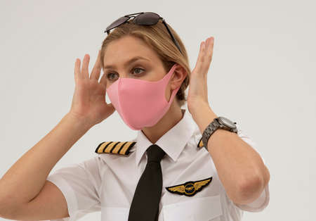 Wiltshire, England, UK. August 2020.  Airline pilot wearing a face mask during the Covid-19...