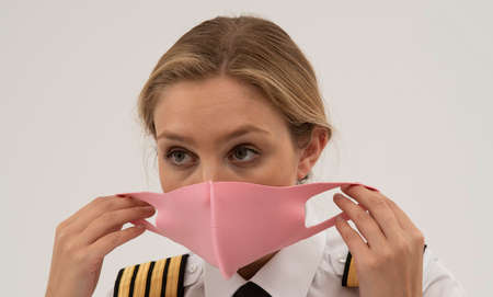 Wiltshire, England, UK. August 2020.  Airline pilot wearing a face mask during the Covid-19...