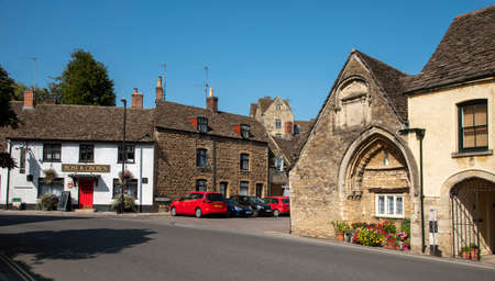 Malmesbury, Wiltshire, England, UK. 2020.  A medieval 12 th century arched doorway formerly a part of the hospital of St John the Baptist with 17th century inscription, lower high street.のeditorial素材