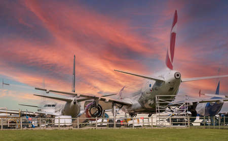 Kemble, Gloucestershire, England, UK. 2020. Under a sunset sky retired jet aircraft  wait to be dismantled and recycled on a Gloucestershire airfield.のeditorial素材