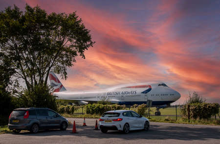 Kemble, Gloucestershire, England, UK. 2020. Under a sunset sky a retired British Airways 747 aircraft  waits to be dismantled and recycled on a Gloucestershire airfield.のeditorial素材