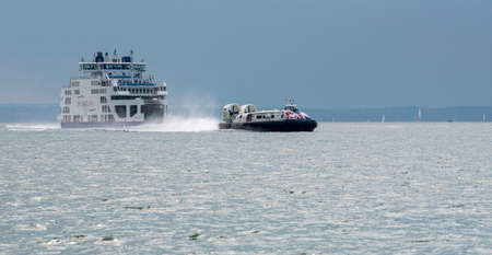 The Solent, Portsmouth, England, UK. 2021.  RORO ferry and a passenger carrying hovercraft seen crossing The Solent a stretch of water between the Isle of Wight and Portsmouth, UKのeditorial素材