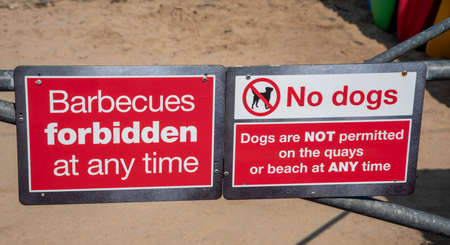 Cornwall, England, UK. 2021. Barbecues and dogs  forbidden red and white sign at entrance to a...