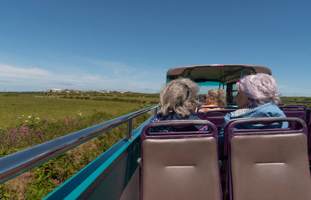 Cornwall, England, UK. 2022. Passengers travelling on a open top tourist bus in the Cornish countryside close to St Just. UKのeditorial素材