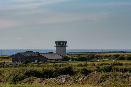 Cornwall, England, UK. 2022. Lands End Airport, control tower andd the sea, close to St Just, Cornwall, UK. Flights fly to the Scilly Isles from this location.のeditorial素材