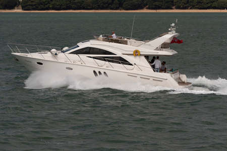The Solent, southern England, UK. 2022.A skippered chartered luxury motorboat underway crossing the Solent heading for Cowes.の写真素材