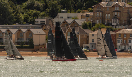 Cowes, Isle of Wight, England, UK. 2022. Racing yachts close to the shore during Cowes Week regatta in Cowes, UK.の写真素材