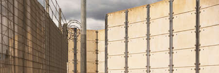 Southern England, UK. 2022. High security wall and wire fencing making  a property secure from intrudersの写真素材
