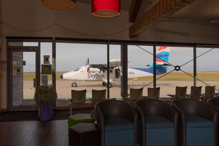 Penzance Airport Cornwall, England, UK. 2022. small passenger plane on the apron with empty boarding lounge.の写真素材