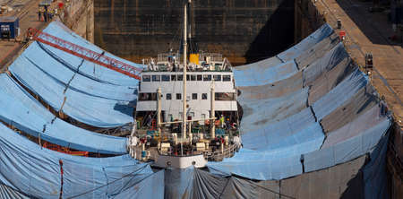 Falmouth, Cornwall, England, UK. 2022.  The historic steamship Shieldhall in dry dock surrounded by tarpaulins whilst work is carried out on the hull of this shipの写真素材