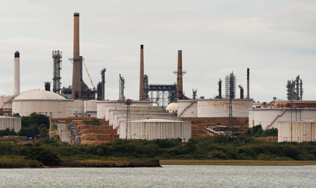 Southampton, southern England, UK. An exterior view of Fawley refinery, storage tanks and chimneys on Southampton Water, UK.のeditorial素材