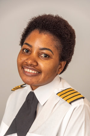 Portrait of a young beautiful woman pilot with afro hairstyle