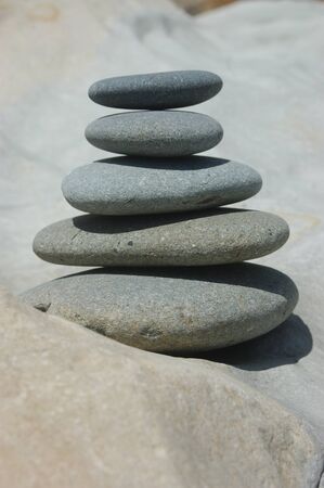 smooth stones stacked up on a smooth rock