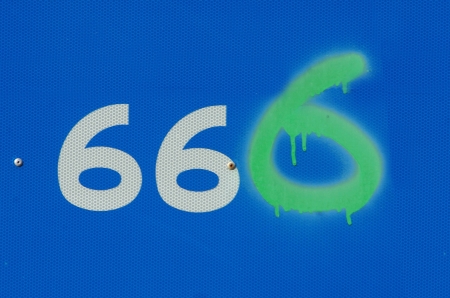 vandalised road sign showing anti christ number 666の写真素材
