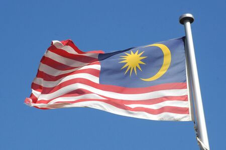 the flag of Malaysia against blue skyの写真素材