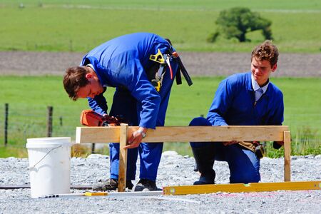 Builders mark out the profile for a building at a construction site in Westland