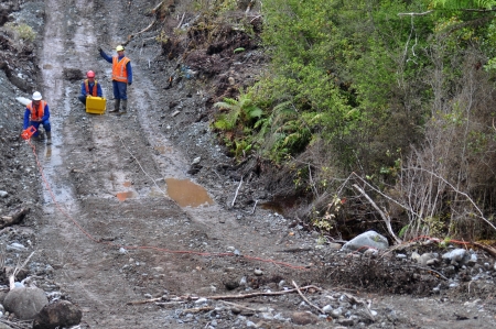 Men setting off explosive charges in a seismic reflective survey looking for oil on the West Coast...
