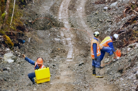 Men setting off explosive charges in a seismic reflective survey looking for oil on the West Coast...
