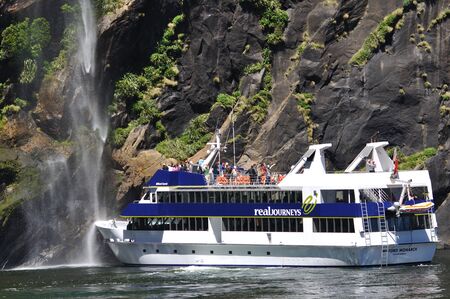 MILFORD SOUND, NEW ZEALAND, JANUARY 8: Visitors enjoy the sights from a tourist launch on 8-1-2011 at Milford Sound in New Zealand. Milford Sound is one of the country's  favourite tourist destinations. のeditorial素材