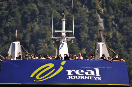 MILFORD SOUND, NEW ZEALAND, JANUARY 8: Visitors enjoy the sights from a tourist launch on 8-1-2011 at Milford Sound in New Zealand. Milford Sound is one of the country's  favourite tourist destinations. のeditorial素材