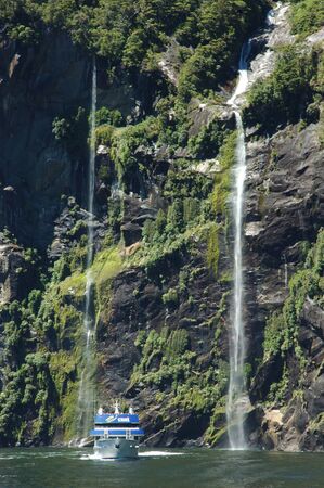 MILFORD SOUND, NEW ZEALAND, JANUARY 8: Visitors enjoy the sights from a tourist launch on 8-1-2011 at Milford Sound in New Zealand. Milford Sound is one of the country's  favourite tourist destinations. のeditorial素材