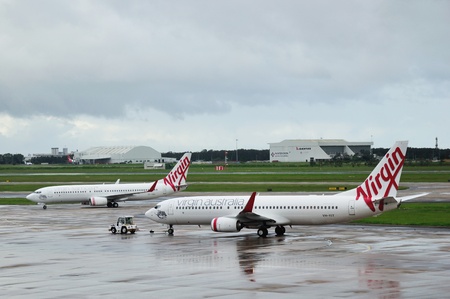 BRISBANE, AUSTRALIA: MARCH 8: commercial airliners from Virgin Airlines lined up on the tarmac on 8-3-2013 at Brisbane International Airport.のeditorial素材