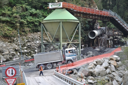 PIKE RIVER COAL MINE, NEW ZEALAND, OCTOBER 28: A coal miner directs a truck near the entrance of the...