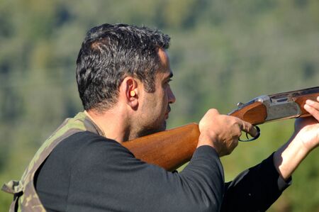 Hunter at the ready with his shotgunの写真素材
