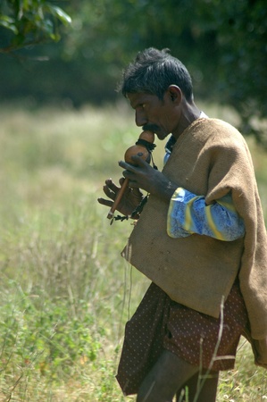 TIRUNELVELI, TAMIL NADU, INDIA,  FEBRUARY 28, 2009: Indian man blows whistle to attract snakes on February 28, 2009 in Tamil Nadu, South India. Snakes are released in a protected area.のeditorial素材