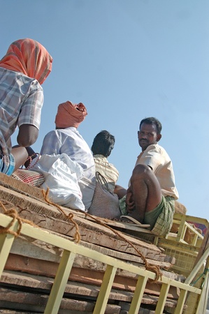 TIRUNELVELI, TAMIL NADU, INDIA,  FEBRUARY 28, 2009: Workers ride on the back of the truck on February 28, 2009 in Tamil Nadu, South India.のeditorial素材