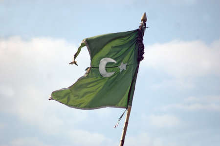 A Moslem flag against blue sky and cloudsの写真素材