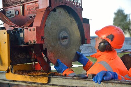 Man changes the blade on a portable sawmill, Westland, New Zealand  の写真素材