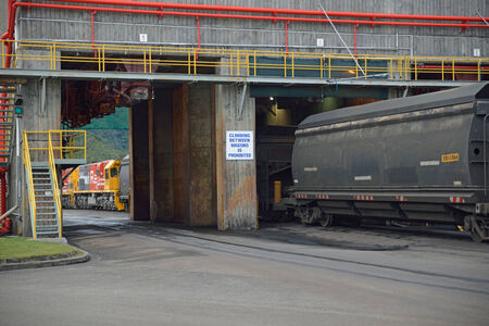 WESTPORT, NEW ZEALAND, JULY 12, 2013: Coal from the Stockton open cast coal mine fills a rail car on July 12, 2013 near Westport, New Zealand. Stockton is the country's largest open cast coal mine.のeditorial素材