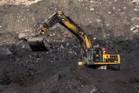 WESTPORT, NEW ZEALAND, AUGUST 31, 2013  40 ton digger removes high grade coal from a seam at an open cast coal mine on August 31, 2013 near Westport, New Zealandのeditorial素材