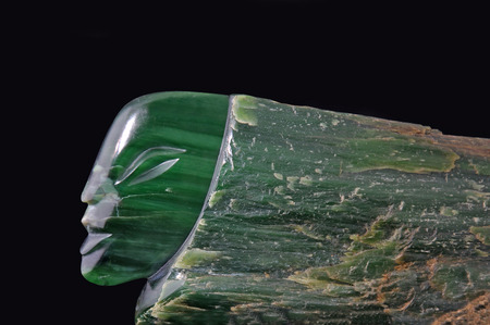 Jade carving of human head in natural greenstone, West Coast, South Island, New Zealand
