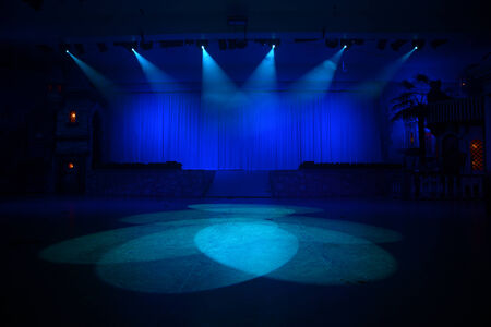 Spotlights converge on an area in front of the stageの写真素材