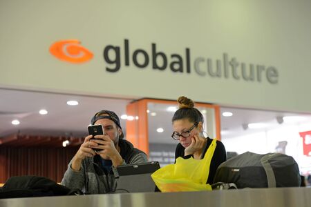 CHRISTCHURCH, NEW ZEALAND, JULY 12, 2015: An unidentified couple absorbed in their digital world...