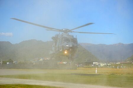 GREYMOUTH, NEW ZEALAND, NOVEMBER 18, 2017: Dust and flying debris obscure an Air Force NH90 helicopter taking off at an open day run by the New Zealand armed forces. The NH90 was built by NATO Helicopter Industries (NHI) (France).のeditorial素材