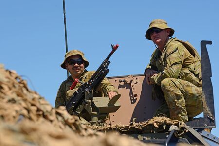 GREYMOUTH, NEW ZEALAND, NOVEMBER 18, 2017: Two unidentified soldiers stand by a Mag 58 GM machine gun at an open day run by the New Zealand armed forces.のeditorial素材