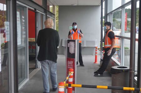 GREYMOUTH, NEW ZEALAND, APRIL 11, 2020: Supermarket staff greet a customer during the Covid 19...