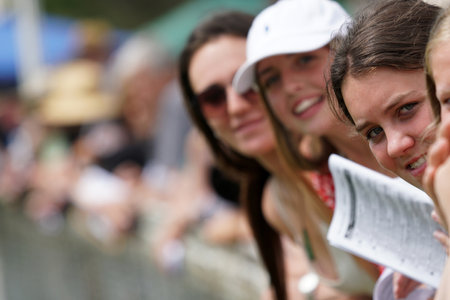 KUMARA, NEW ZEALAND, JANUARY 8, 2022; Young women line up at the fence to watch a race at the Gold Nuggets competition at the Kumara Race Track, January 8, 2022 .のeditorial素材