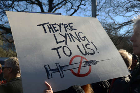 CHRISTCHURCH, NEW ZEALAND, JULY 24, 2021; Detail of a placard at a protest rally at the Bridge of Remembrance in  Christchurch. Activists spoke against increasing government control over Covid vaccinations, farm taxes and civil liberties.のeditorial素材