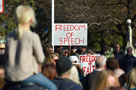 CHRISTCHURCH, NEW ZEALAND, JULY 24, 2021; Detail of a placard at a protest rally at the Bridge of Remembrance in  Christchurch. Activists spoke against increasing government control over Covid vaccinations, farm taxes and civil liberties.のeditorial素材