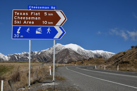 PORTERS PASS, NEW ZEALAND, SEPTEMBER 20, 2020:  Signage directs traffic to the Cheeseman Ski Area off State Highway 73 near Porters Pass. The Torlesse Range can be seen in the background.のeditorial素材
