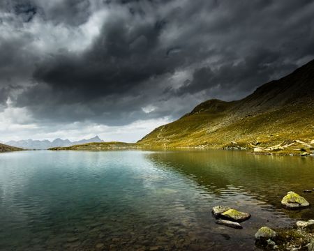Mountain lake with storm and dark clouds, Engadin, Switzerlandの写真素材